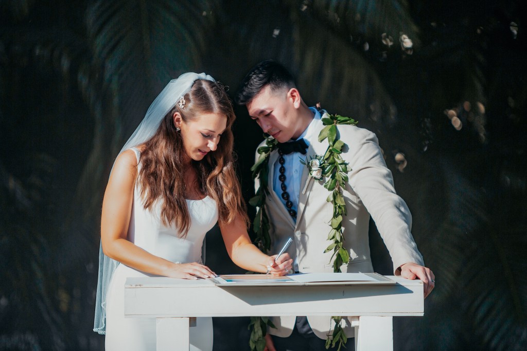 bride and groom signing marriage license during ceremony in destination wedding in mexico
