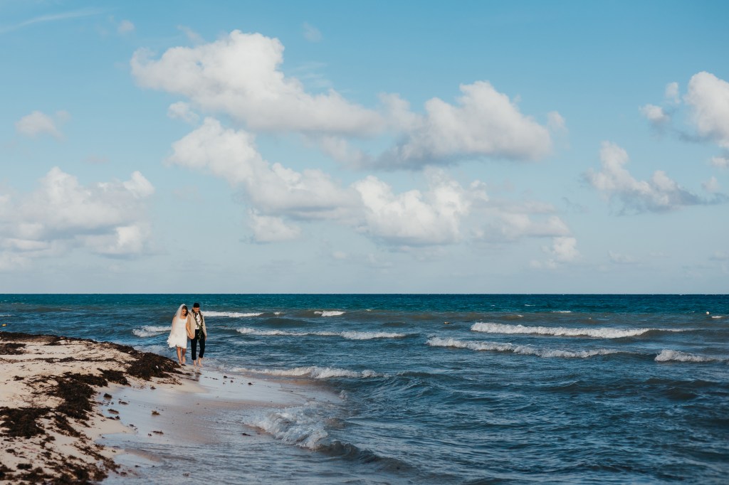 bride and groom walking on the beach in Playa Del Carmen Mexico
