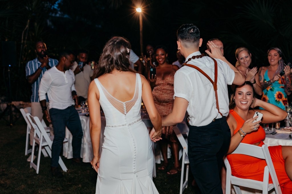 bride and groom entering reception at outdoor destination wedding in mexico