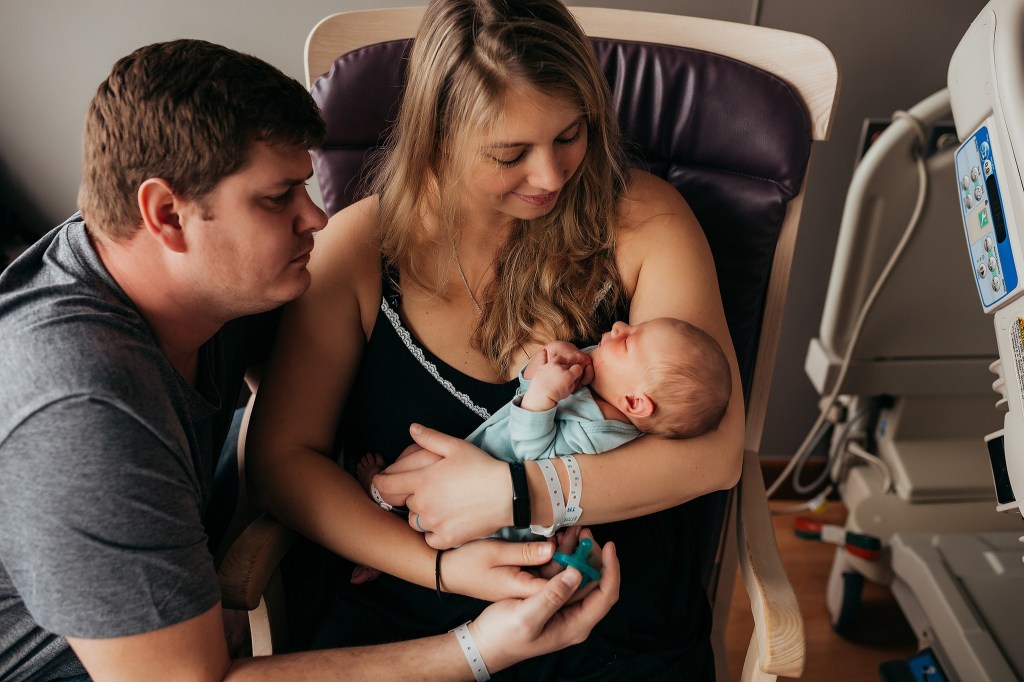 Parents holding baby for the first time in the hospital